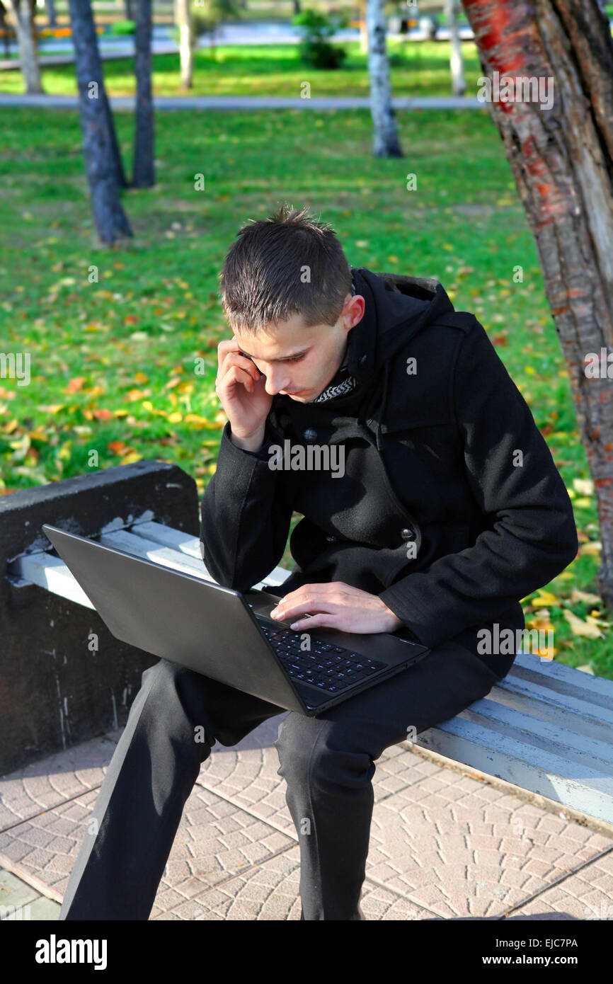 Young Man with Laptop outdoor Stock Photo - Alamy