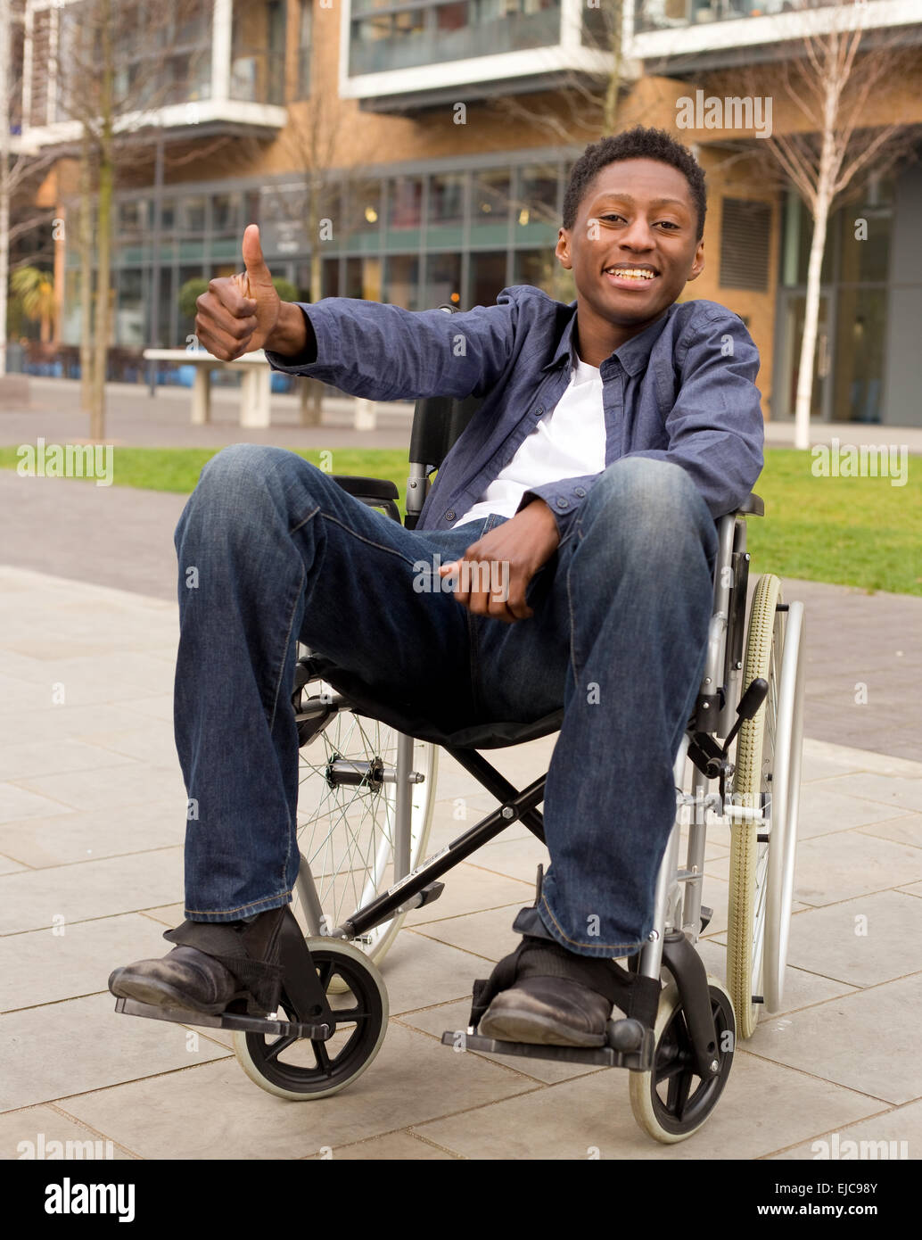 young wheelchair user showing the thumbs up symbol Stock Photo