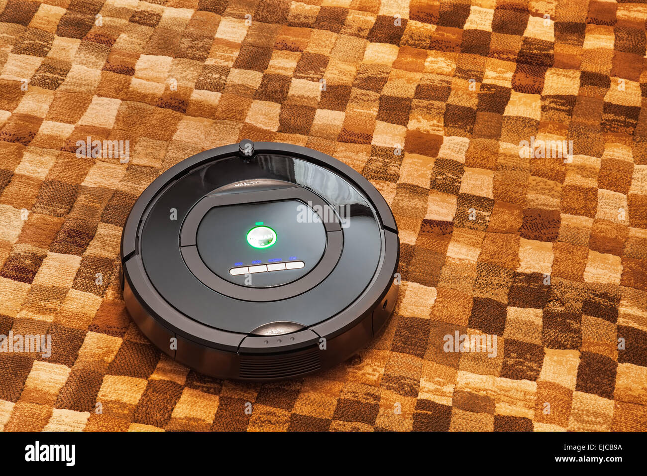 Robotic vacuum cleaner on carpet Stock Photo Alamy