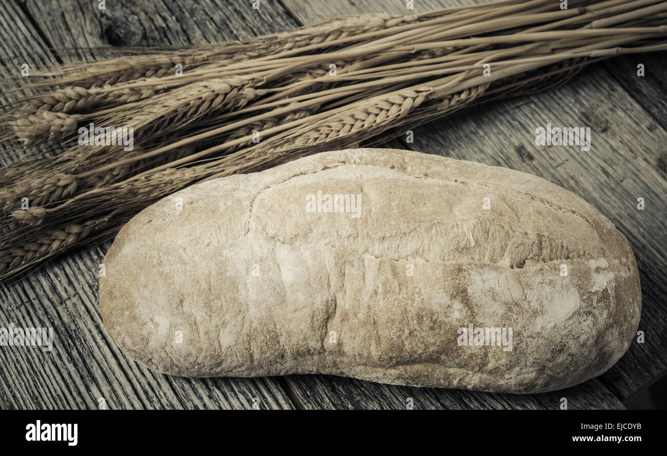 Bread and Wheat on Rustic Wood Background Stock Photo - Alamy