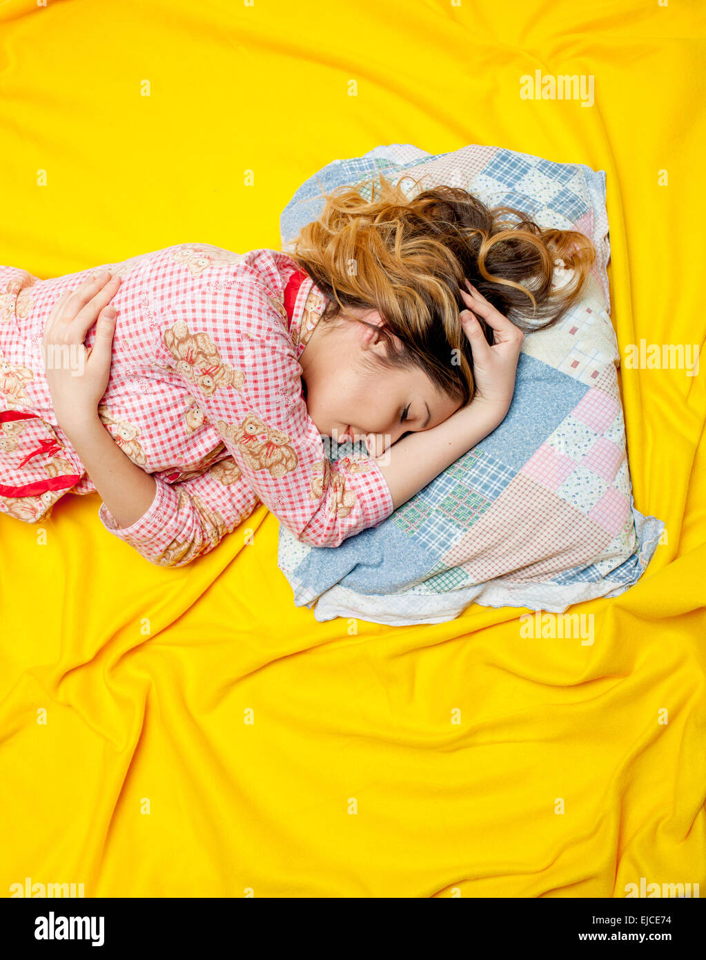 girl sleeping on the yellow sheet Stock Photo Alamy