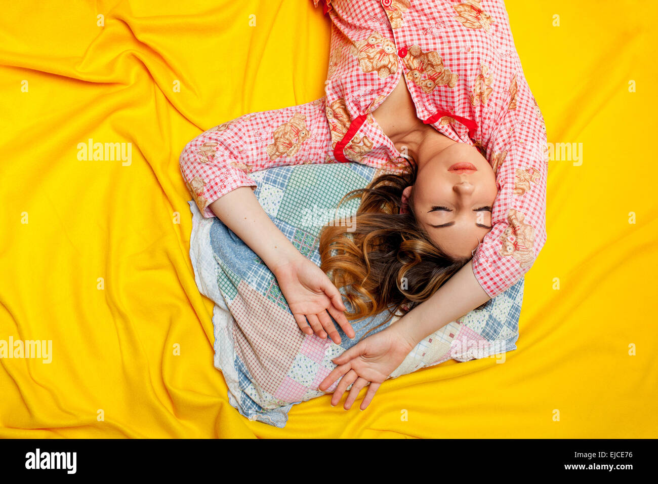 girl sleeping on the yellow sheet Stock Photo Alamy
