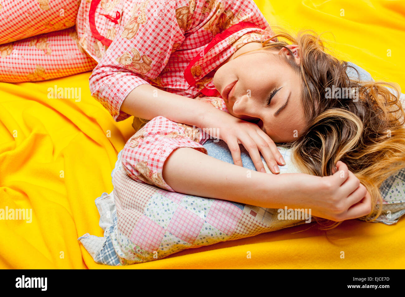 girl sleeping on the yellow sheet Stock Photo Alamy