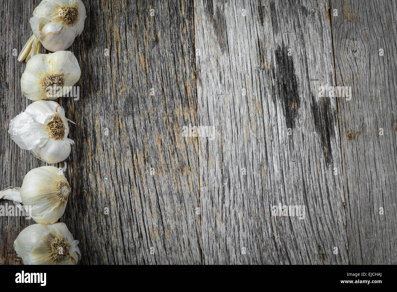 Garlic on Rustic Wood Background Stock Photo - Alamy