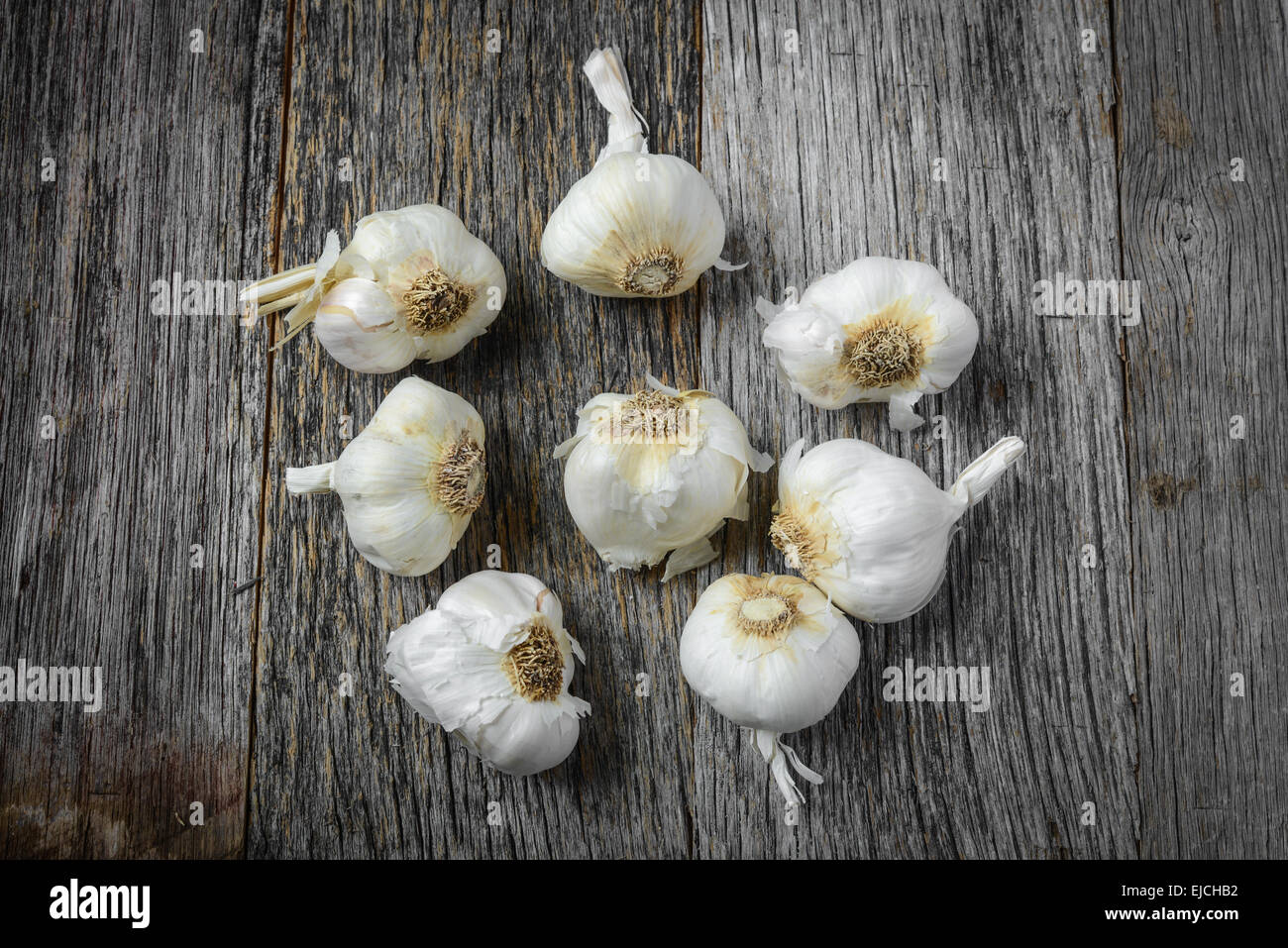 Garlic on Rustic Wood Background Stock Photo - Alamy
