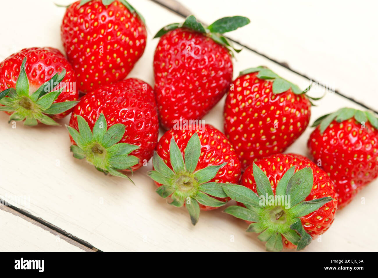 fresh organic strawberry over white wood Stock Photo - Alamy