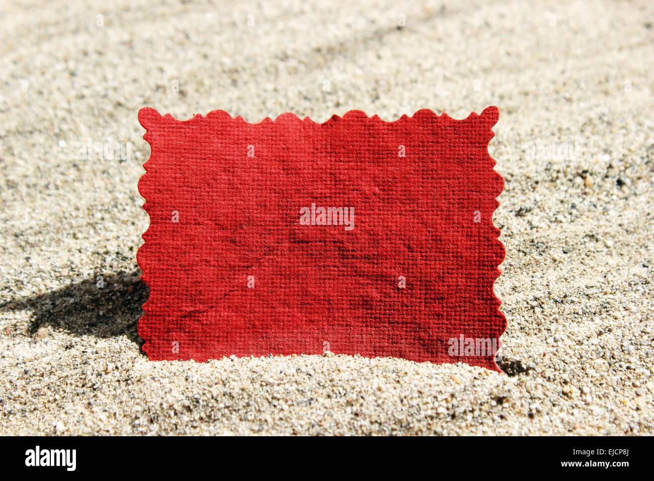 Blank Red Message Note Card in Sand Stock Photo