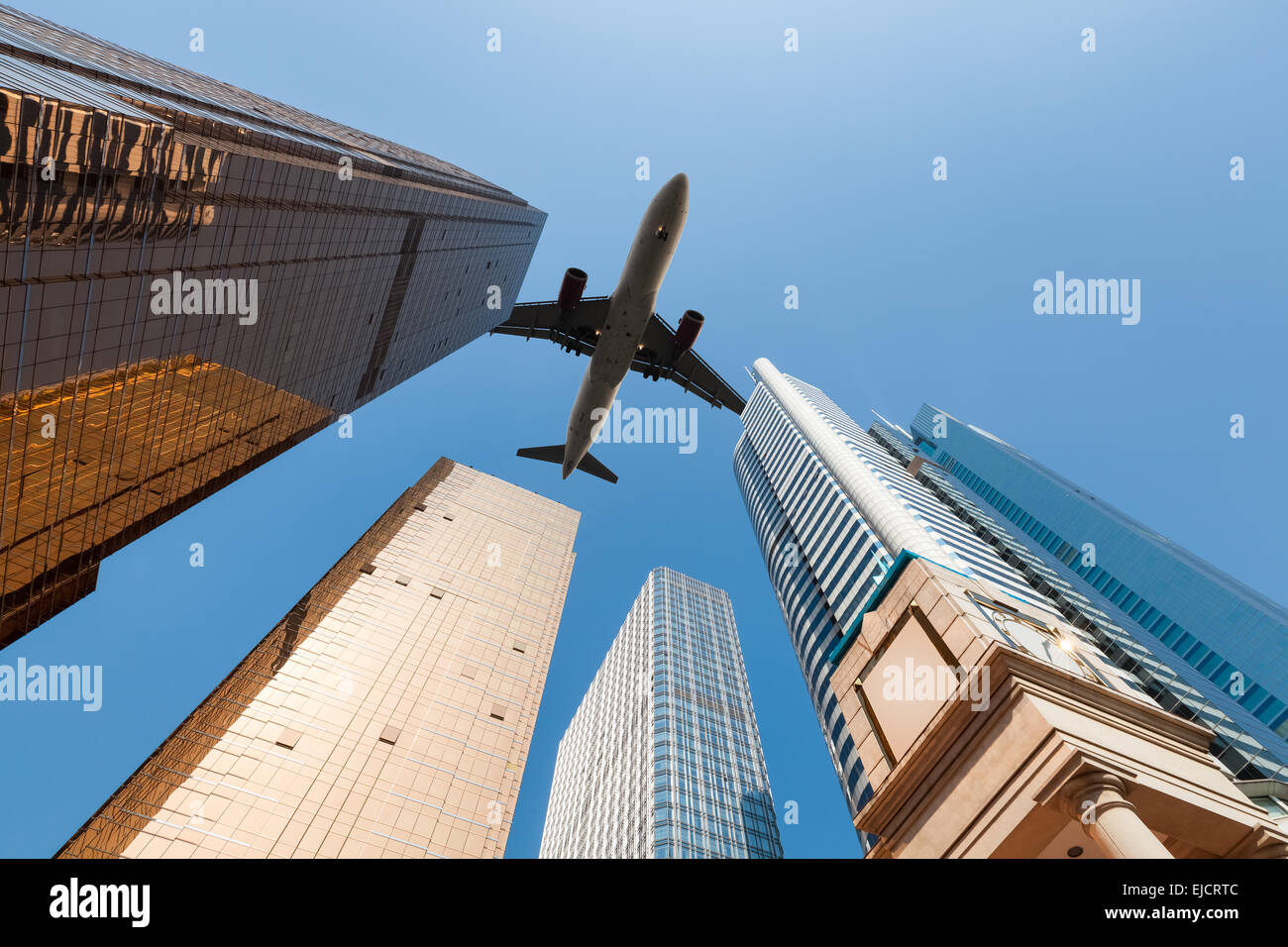 modern building underneath airplane Stock Photo