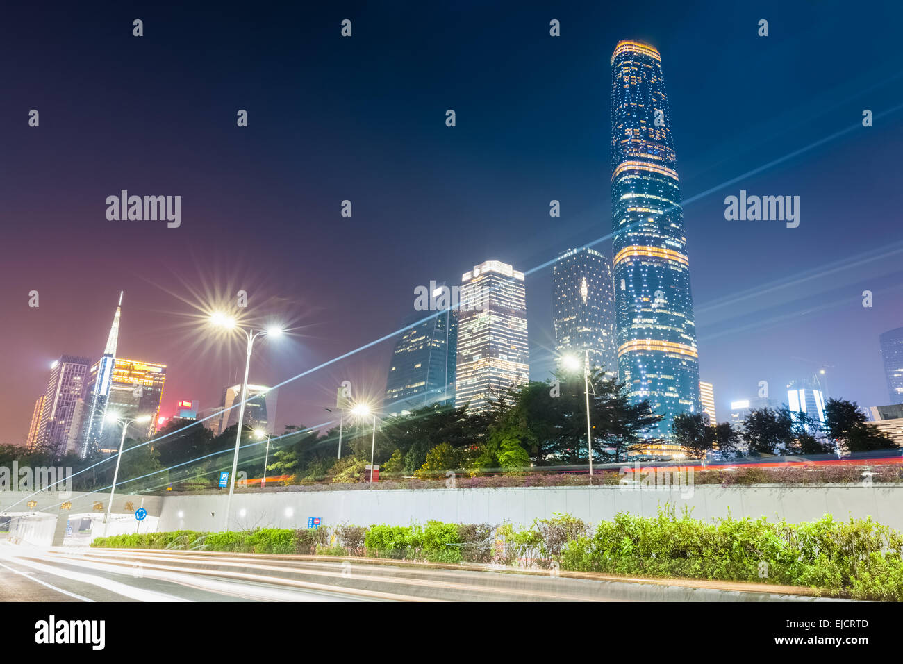 light trails with modern city at night Stock Photo