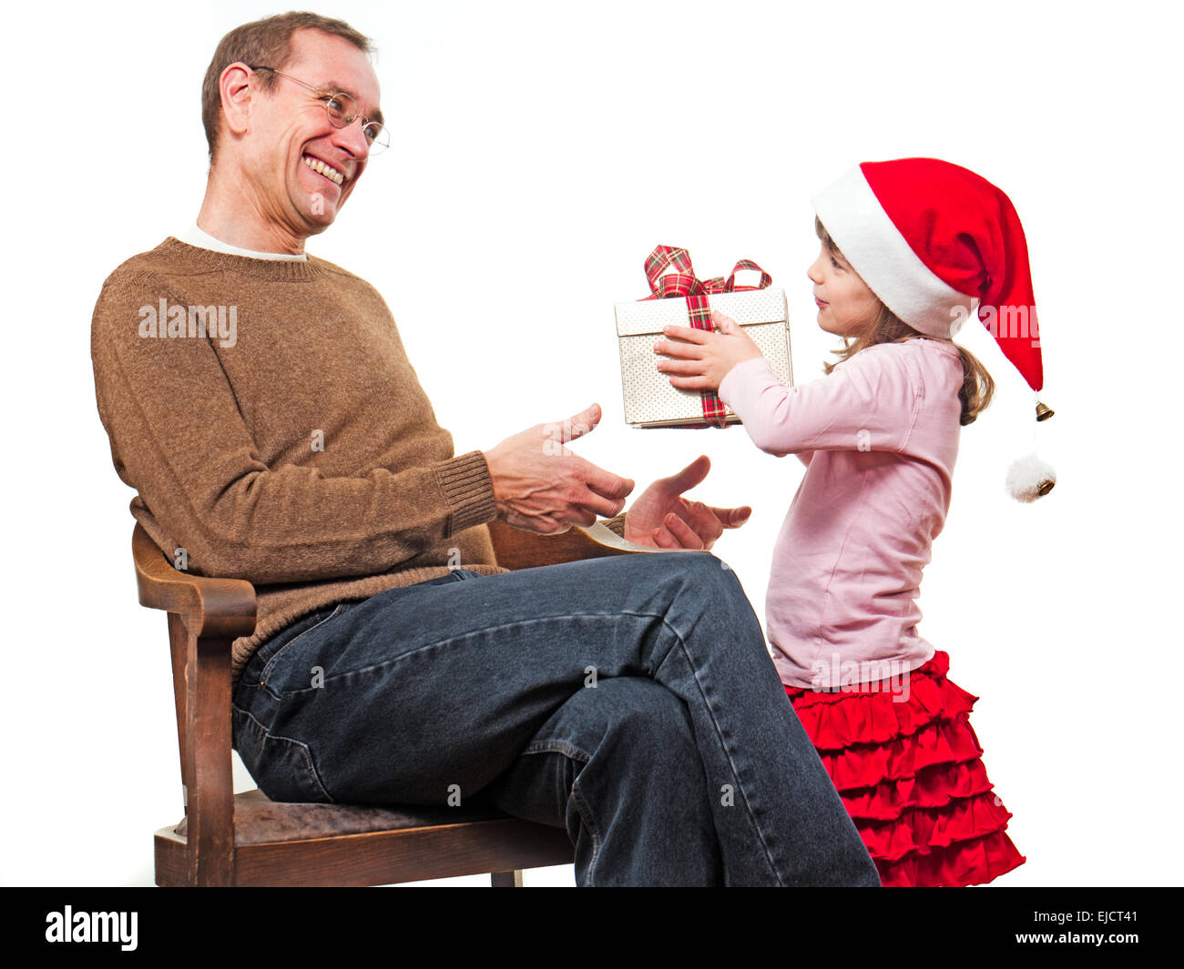Little girl presents gift to her  father Stock Photo
