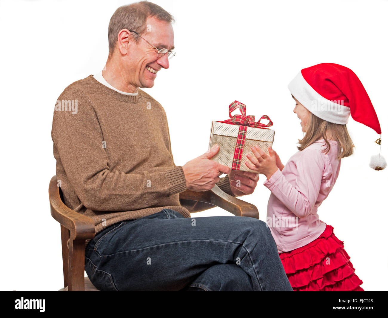 Little girl presents gift to her  father Stock Photo