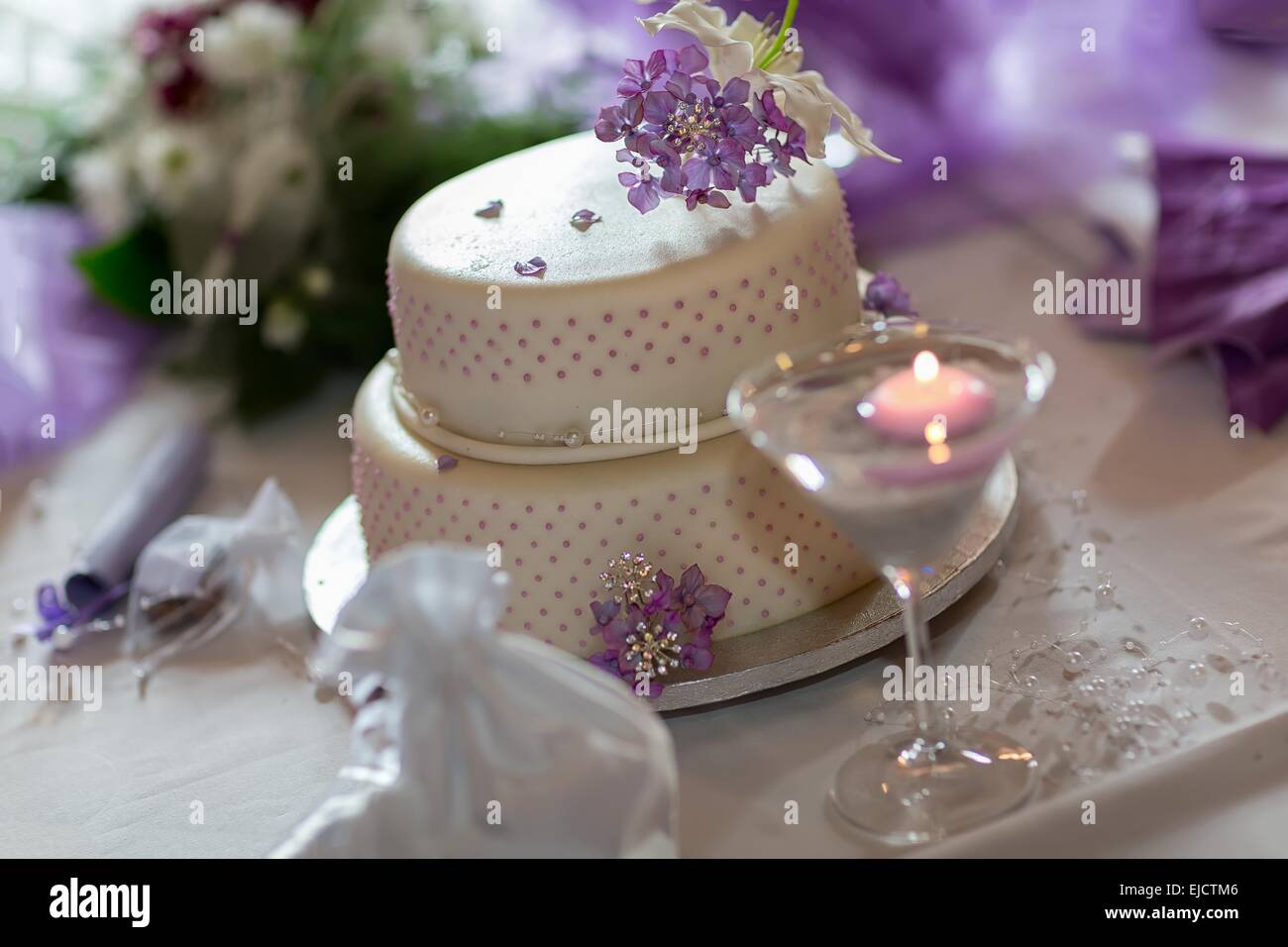 Traditional wedding cake with purple flowers Stock Photo