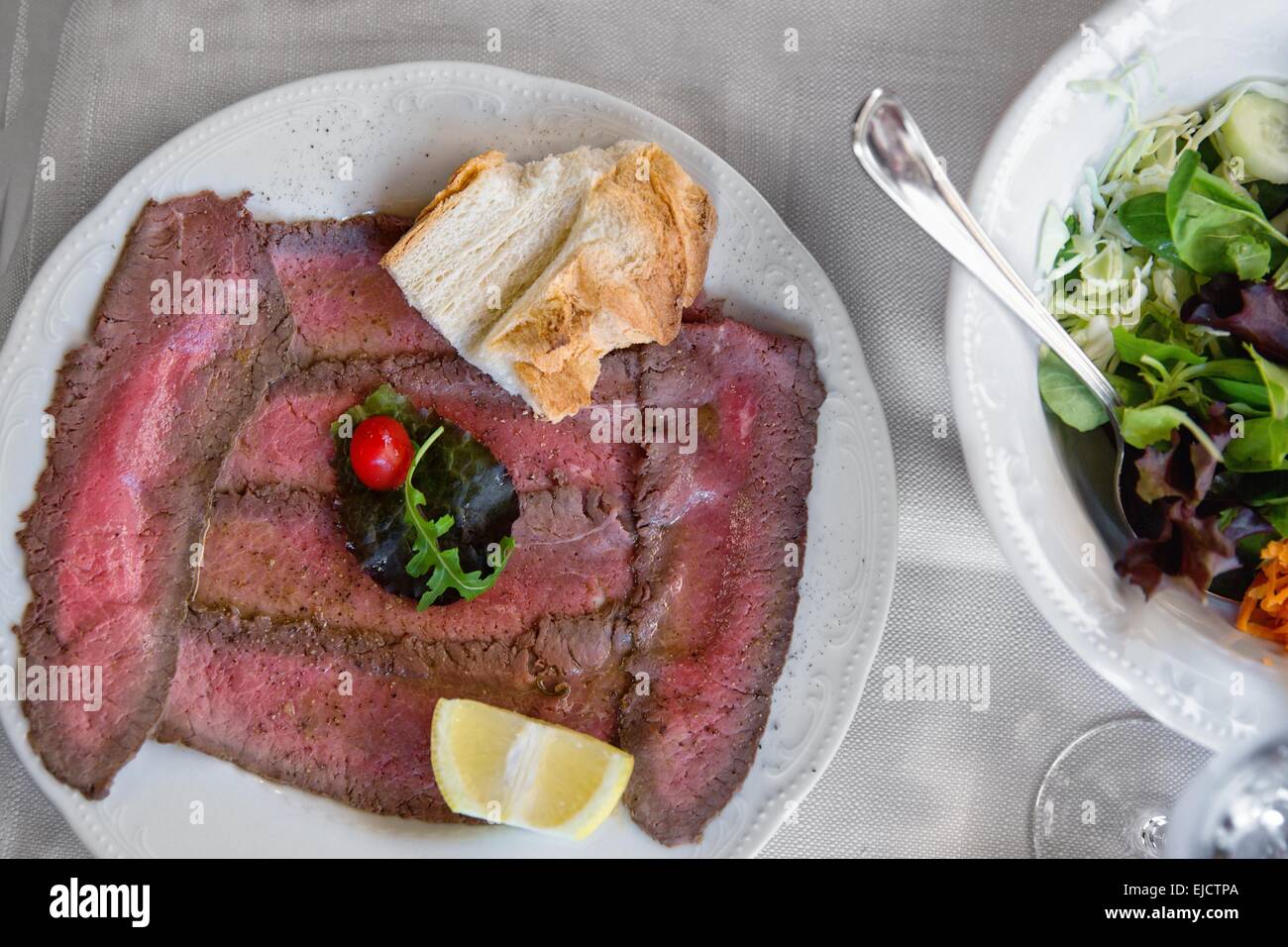 Well roast beef thinly sliced Stock Photo Alamy