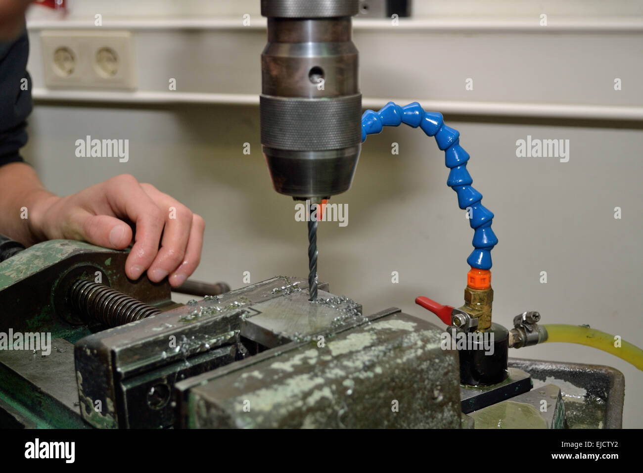 Metal working with electric drill Stock Photo