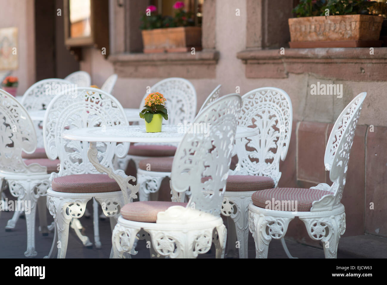 White cafe tables and chairs at outdoor cafe, Ribeauville, Alsace
