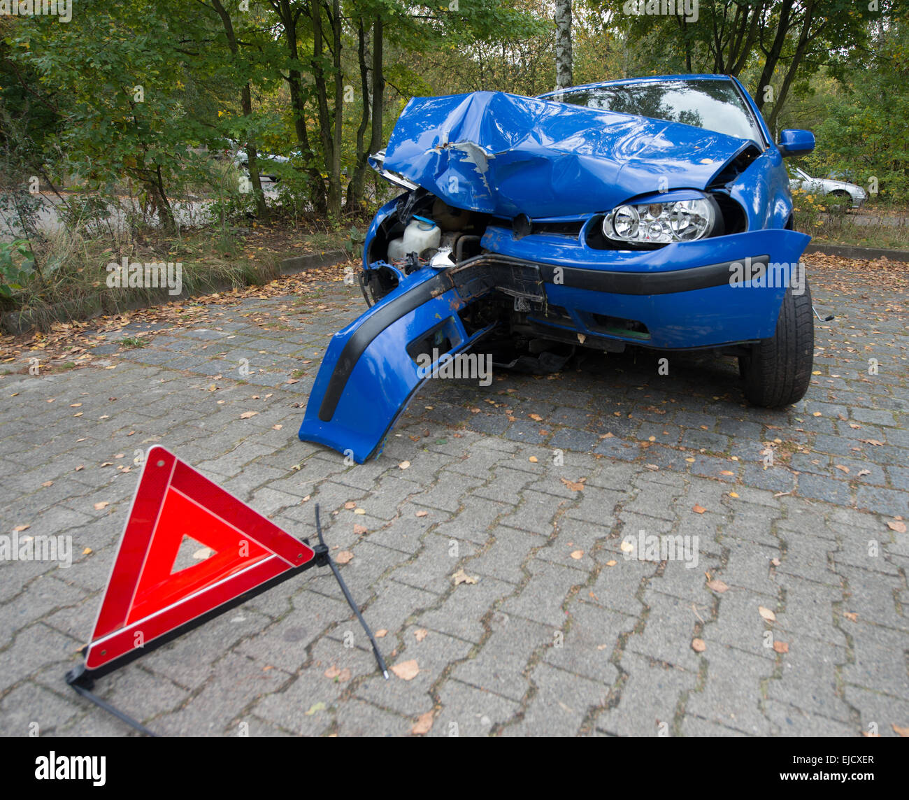 Damaged car with warning triangle Stock Photo