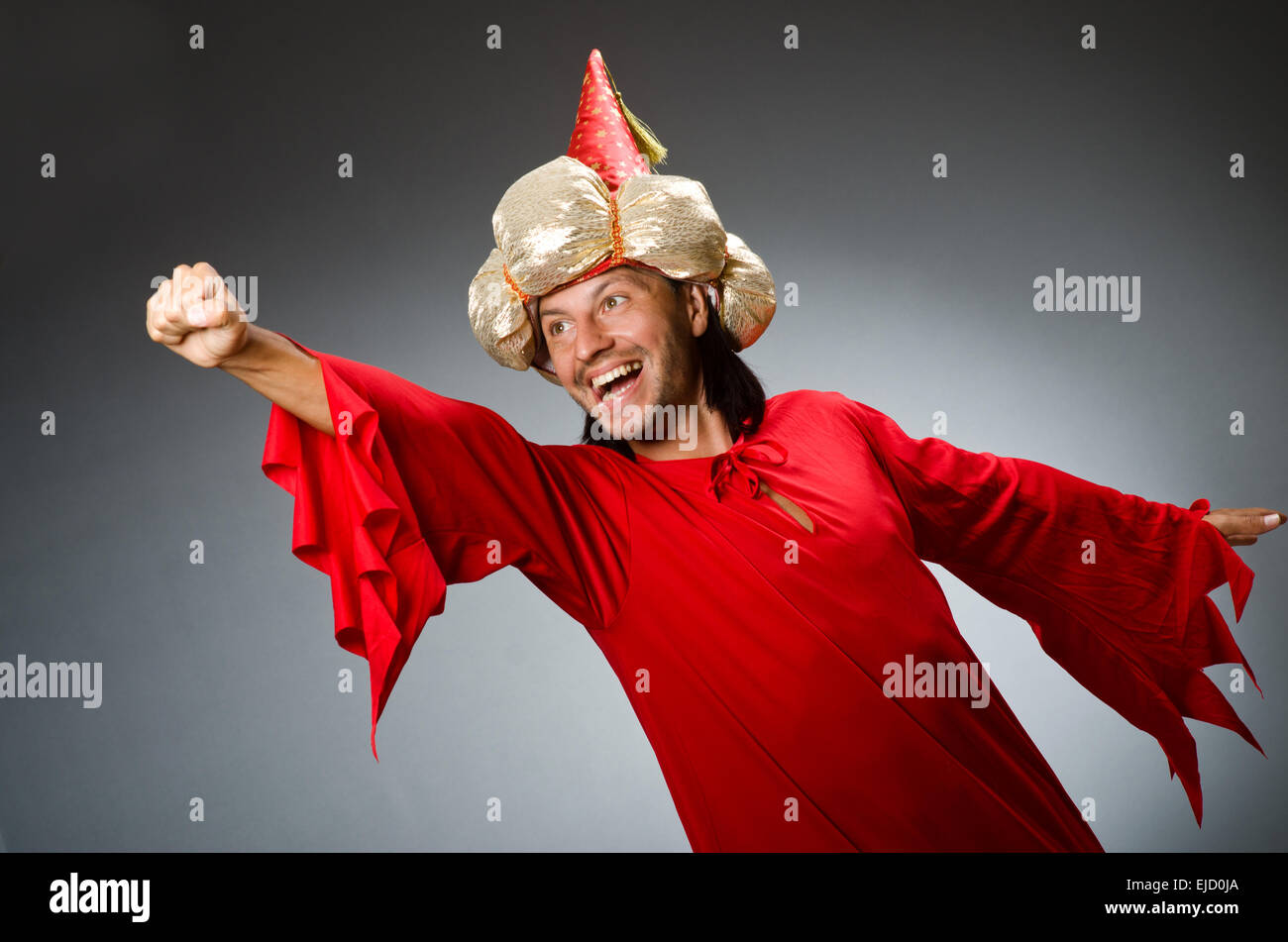 Funny wizard wearing red dress Stock Photo - Alamy