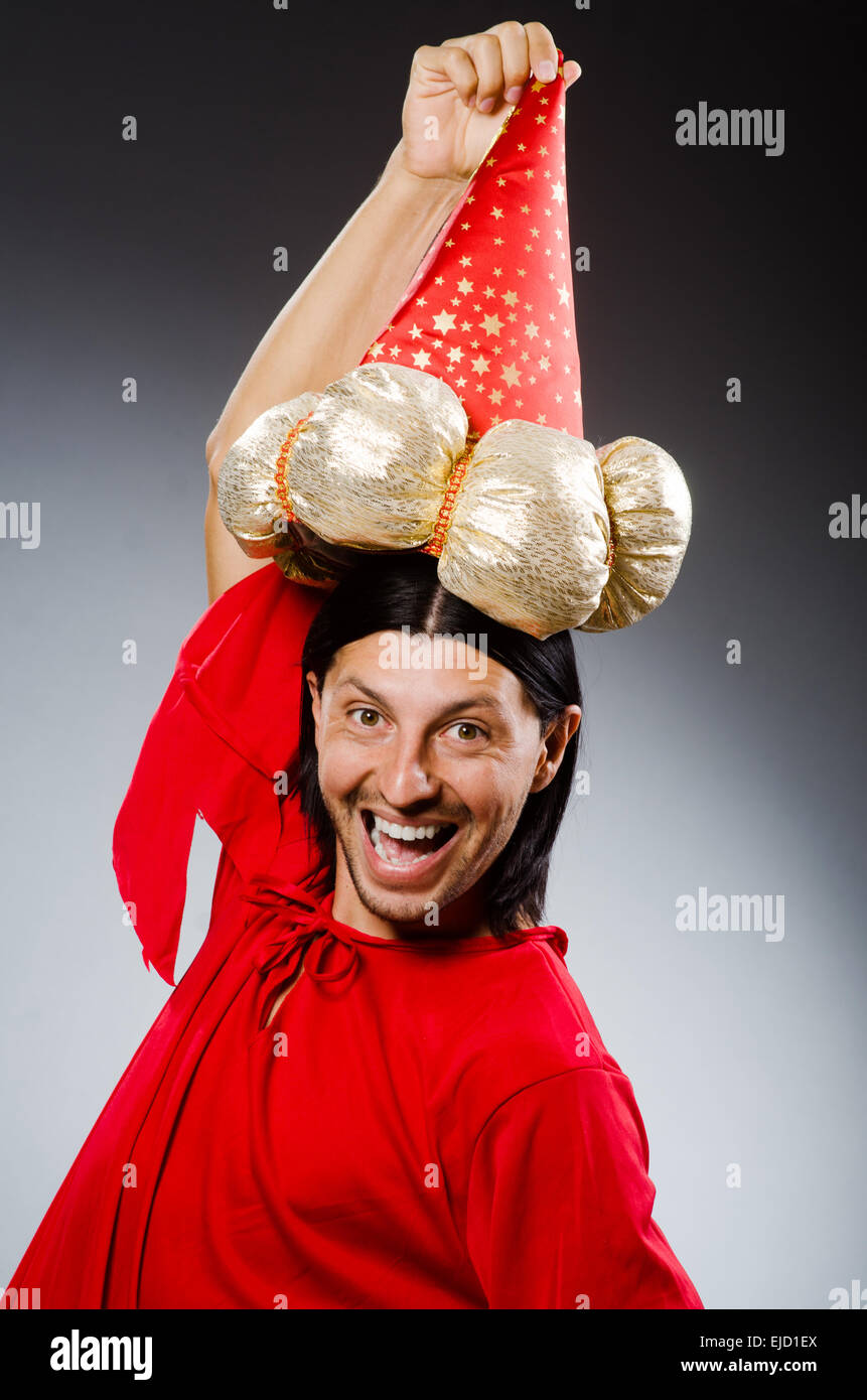 Funny wizard wearing red dress Stock Photo