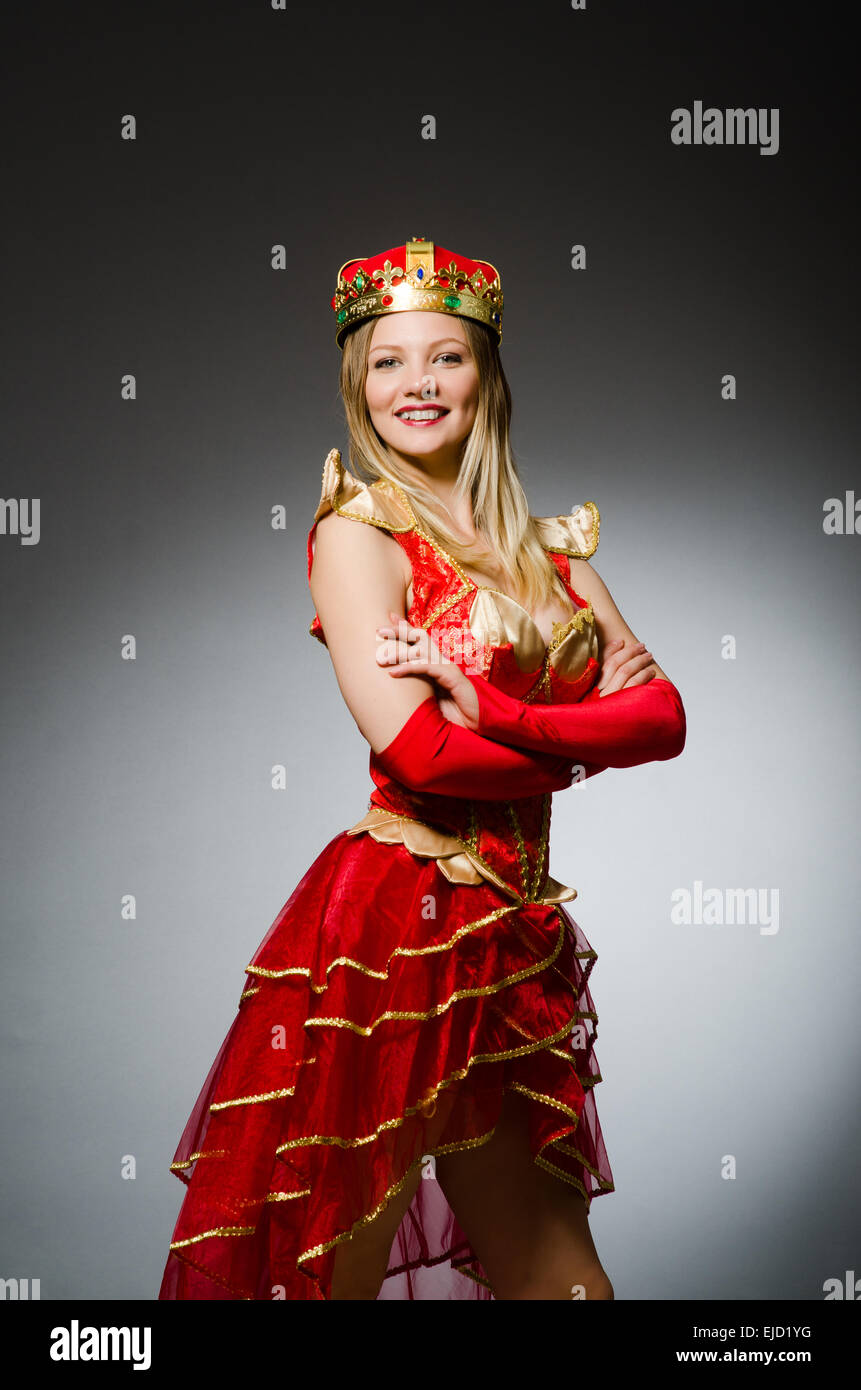 Queen in red costume against dark background Stock Photo - Alamy