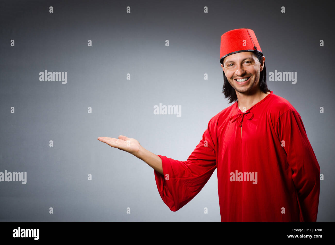 Man in red dress wearing fez hat Stock Photo Alamy