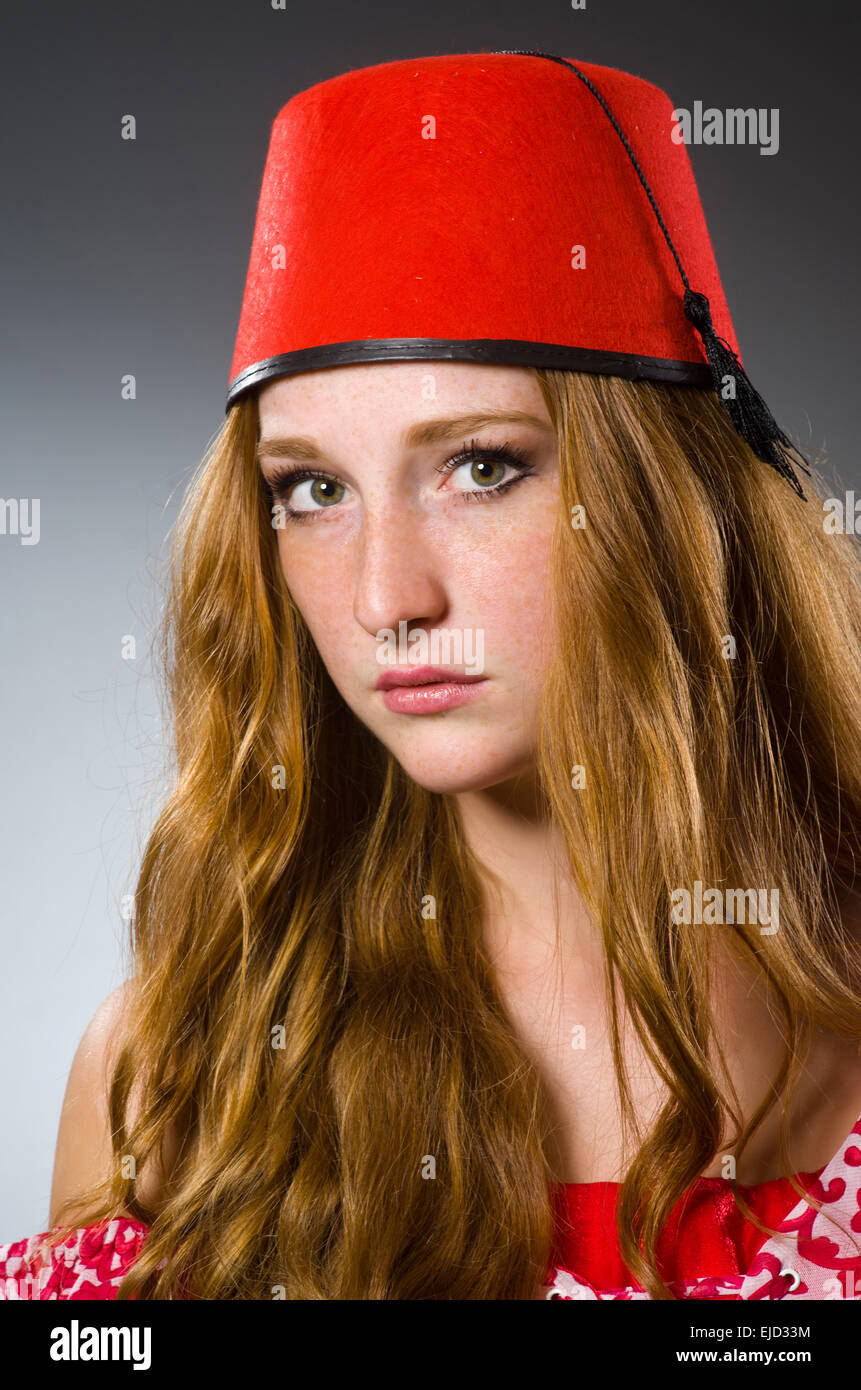 Woman wearing red fez hat Stock Photo - Alamy