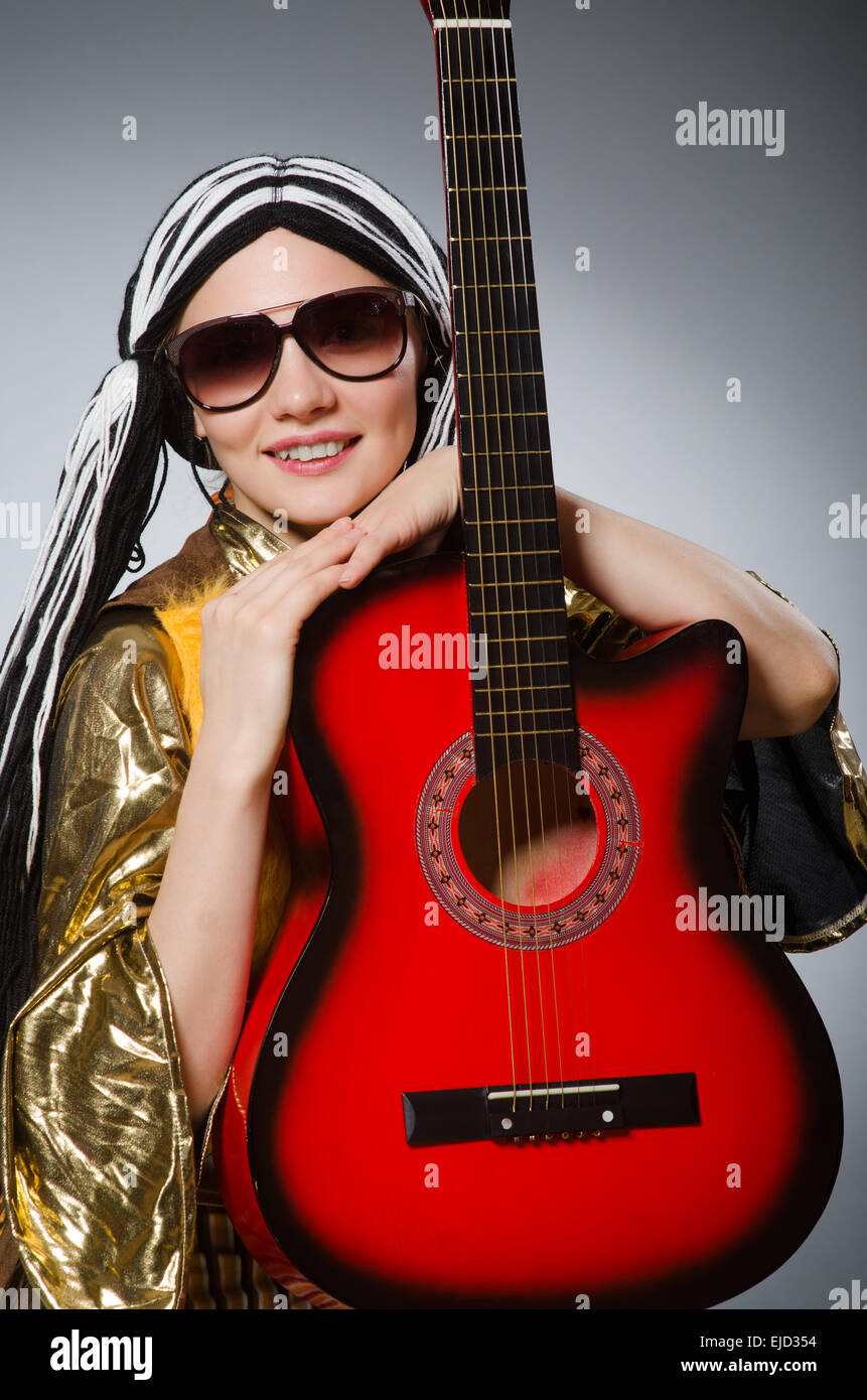 Guitar player with red instrument Stock Photo - Alamy