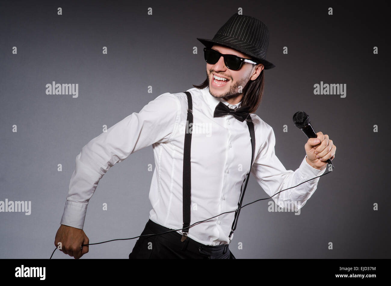 Funny singer with microphone at the concert Stock Photo - Alamy