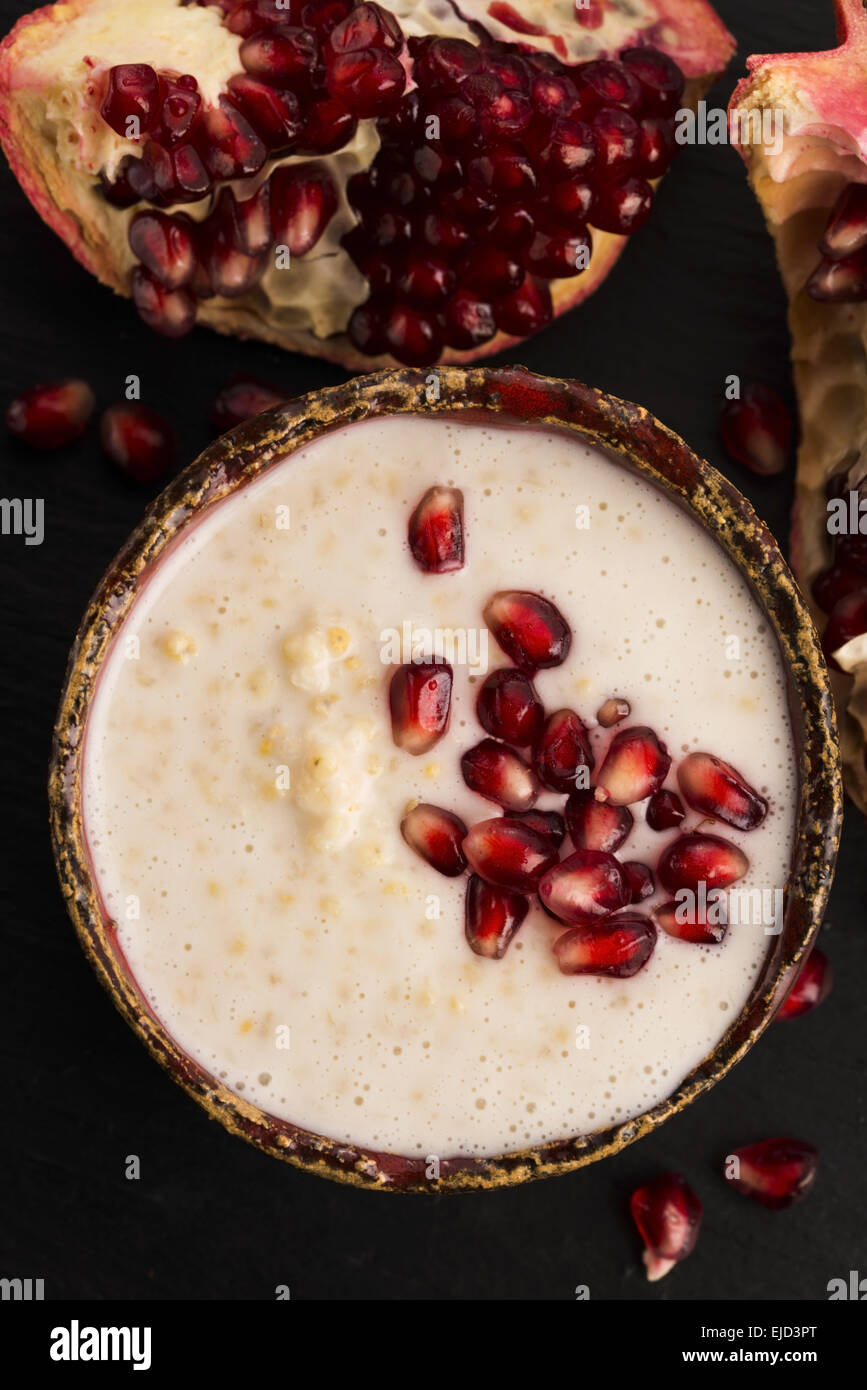 Dish of banana millet breakfast pudding with pomegranate Stock Photo