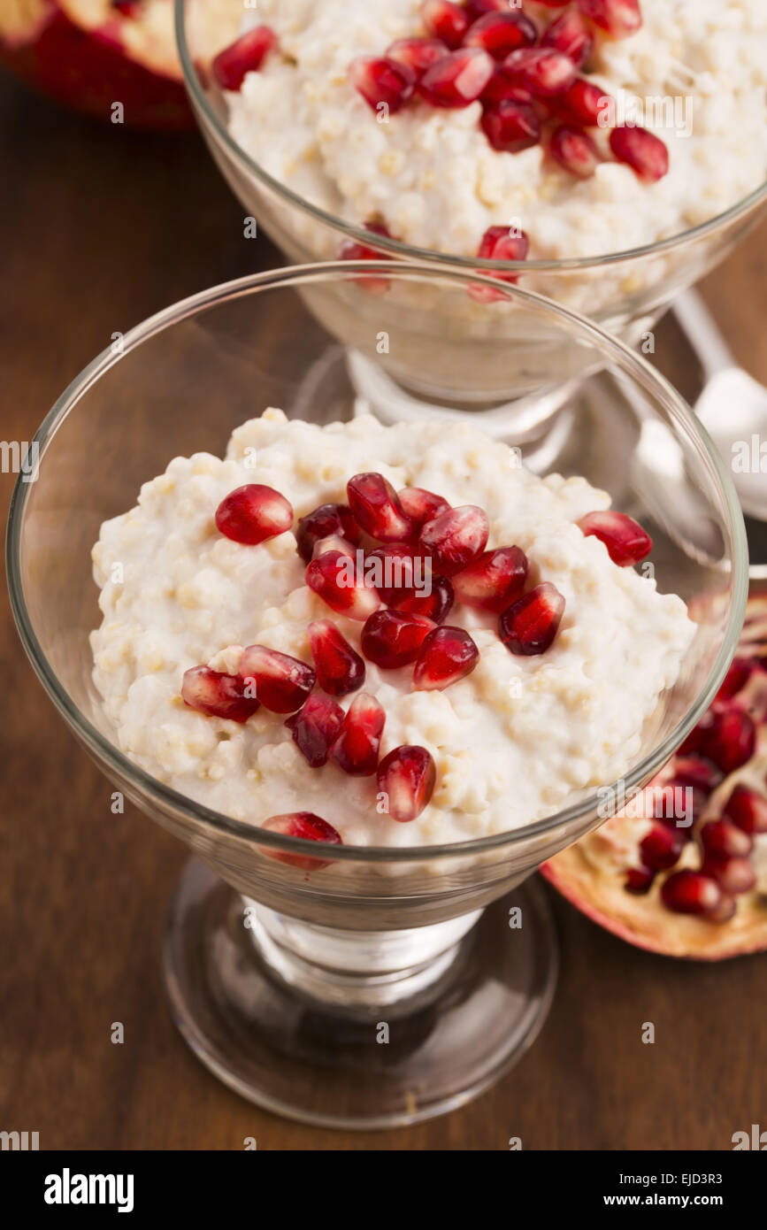 Dish of banana millet breakfast pudding with pomegranate Stock Photo