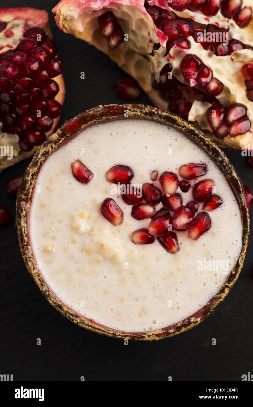 Dish of banana millet breakfast pudding with pomegranate Stock Photo