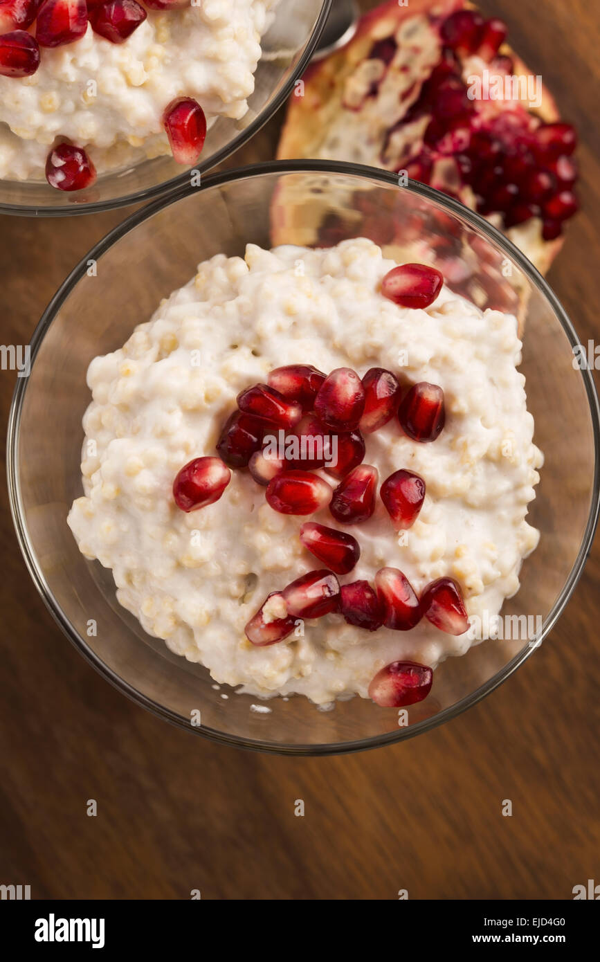 Dish of banana millet breakfast pudding with pomegranate Stock Photo