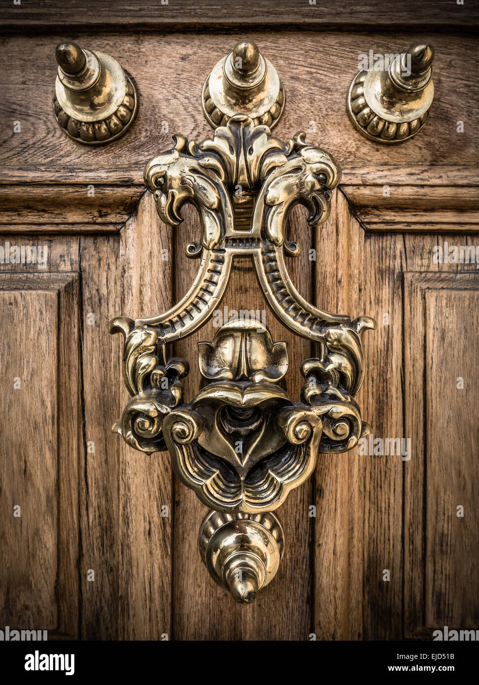 A Grand Ornate Brass Door Knocker On A Heavy Wooden Door In Spain Stock Photo