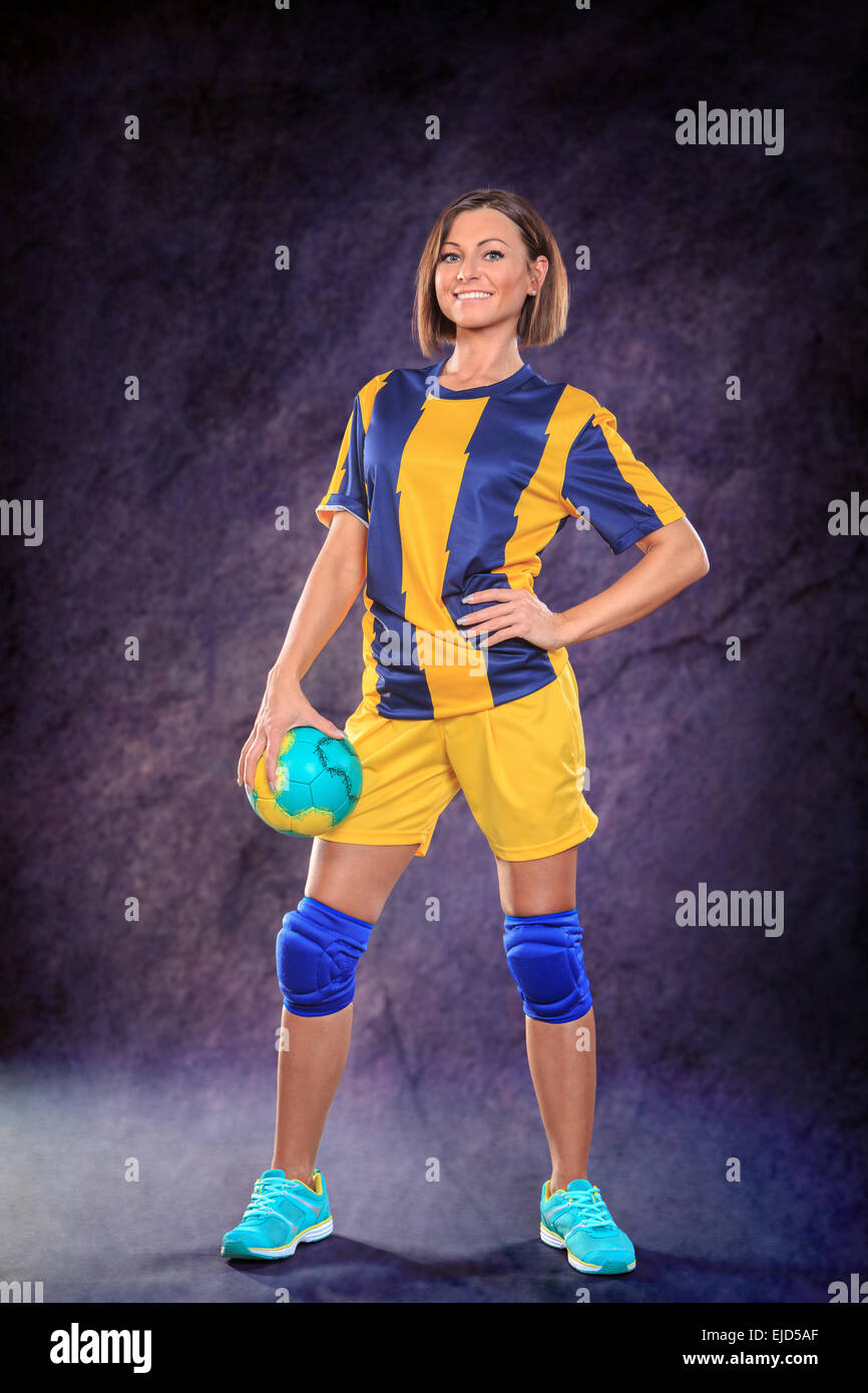 female handball player with a ball on the field Stock Photo