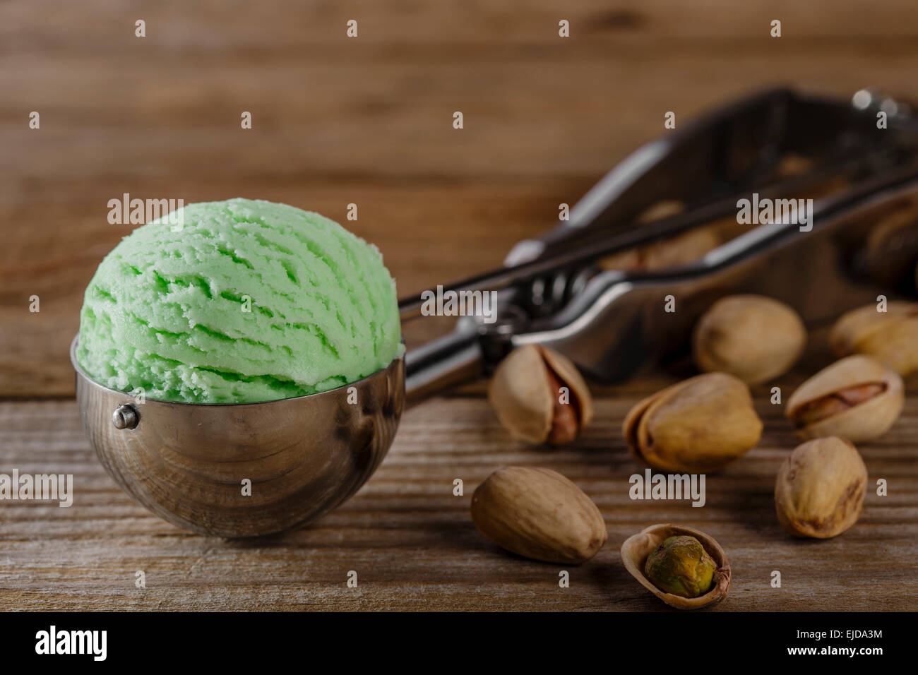 pistachio ice cream ball in a spoon scoop Stock Photo