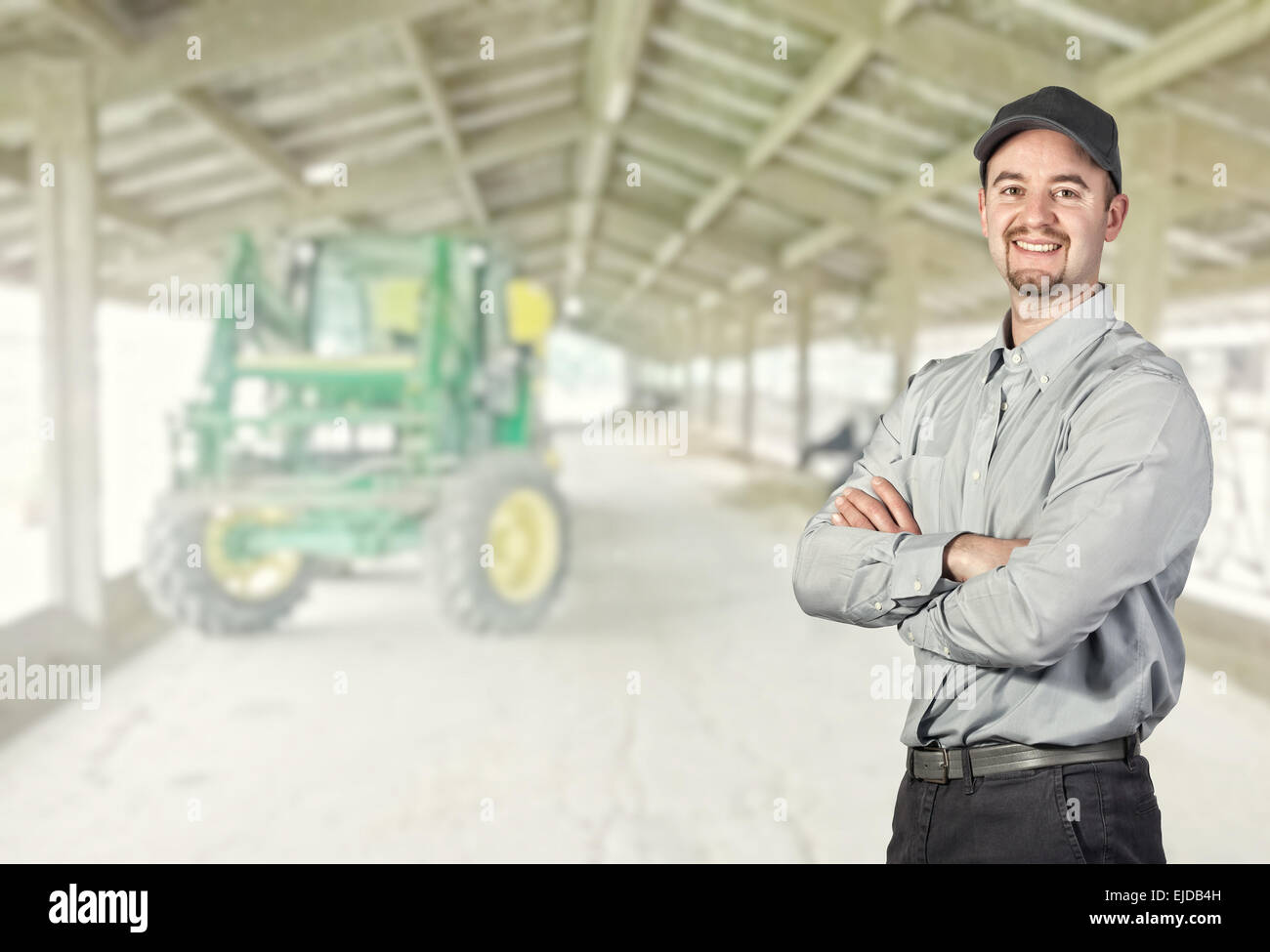 smiling farmer portrait and farm background Stock Photo