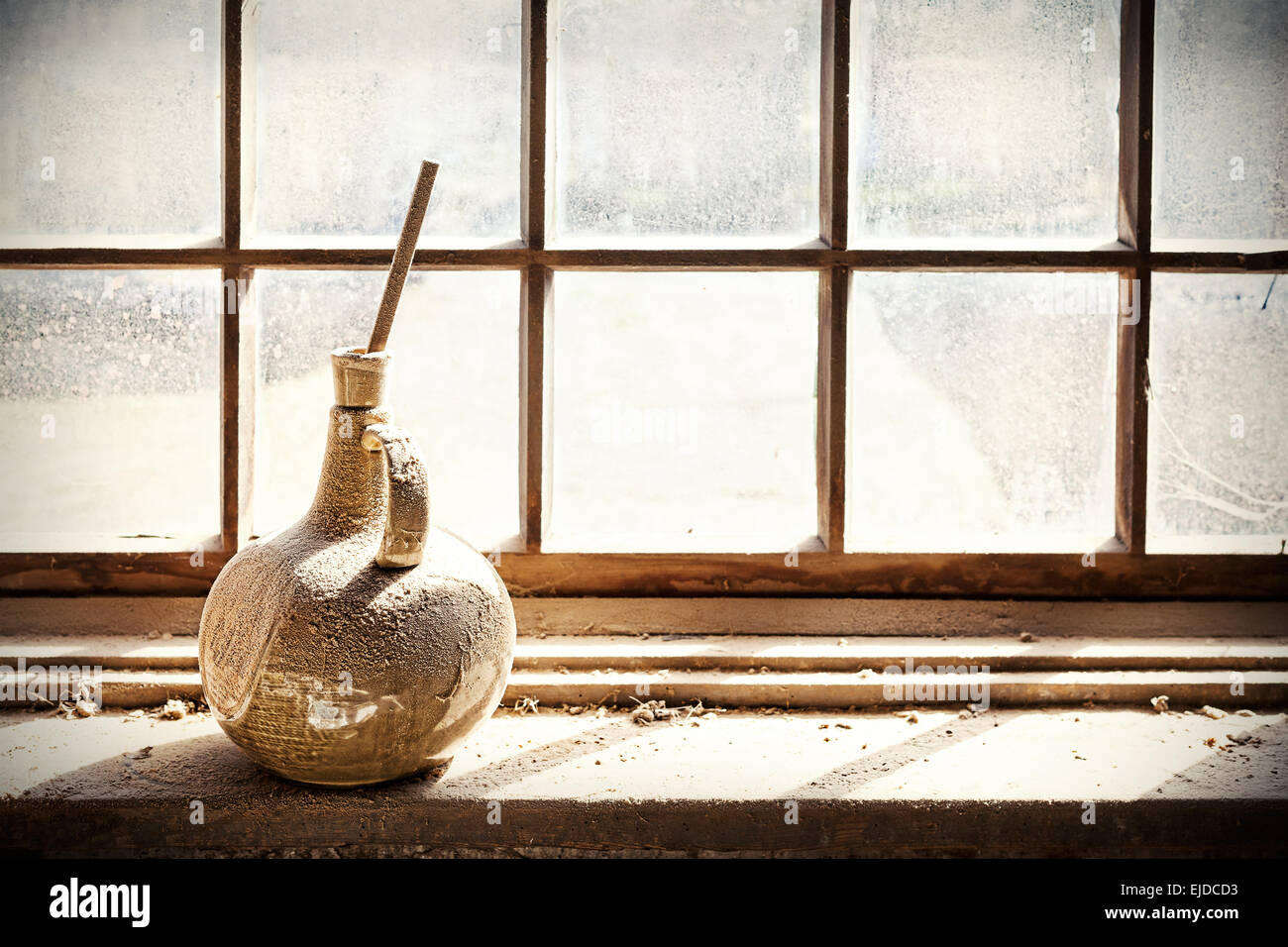 Retro filtered rustic background, old vase on grungy window. Stock Photo