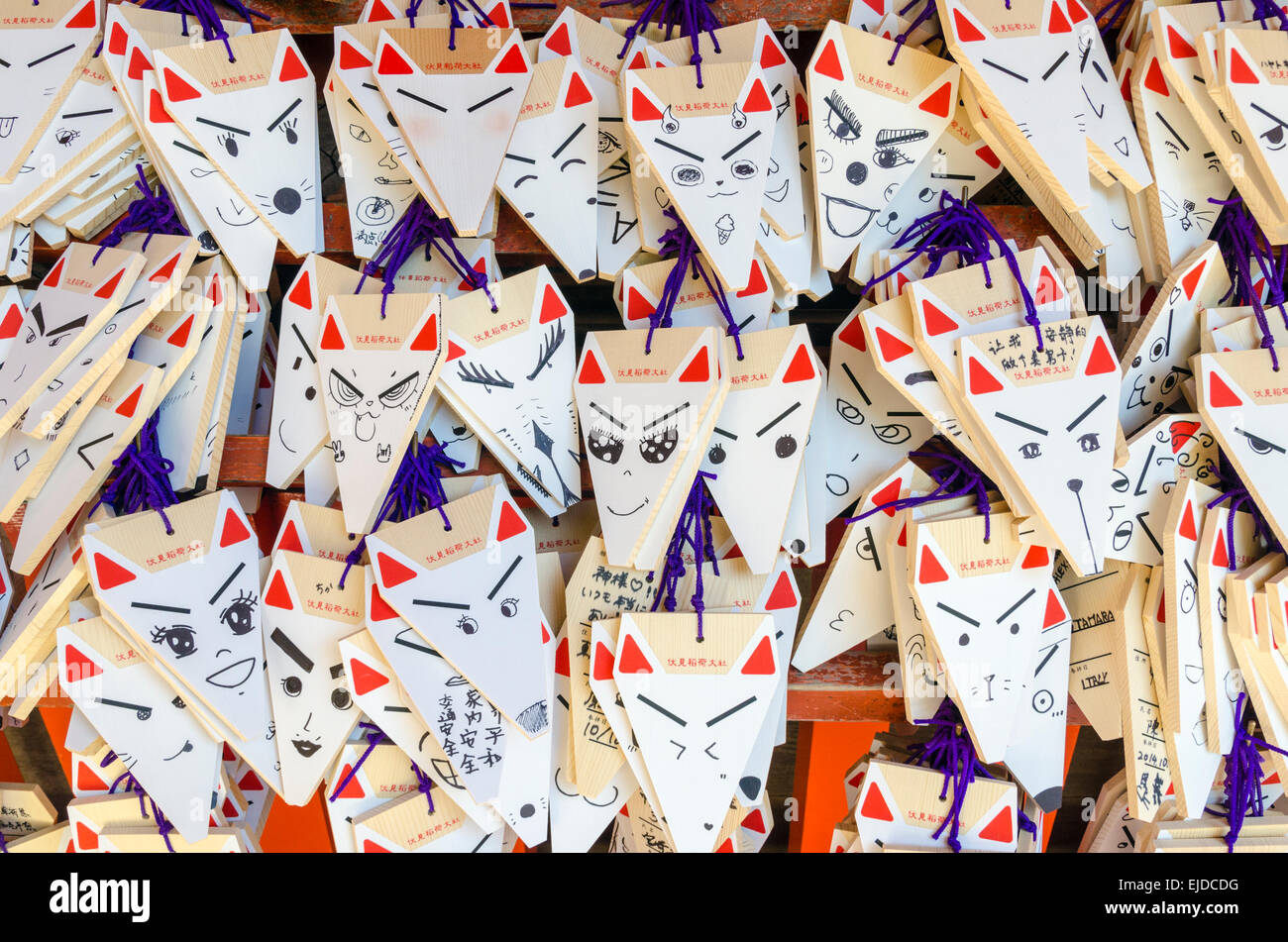 Fox head shaped wooden prayers and wishes at the Fushimi Inari Shrine, Kyoto, Japan Stock Photo