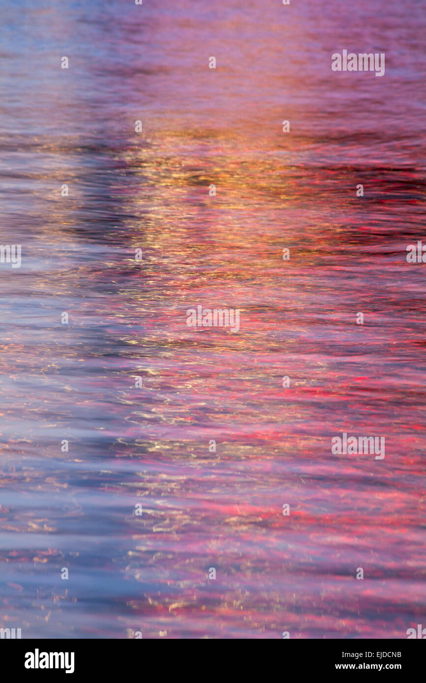 abstract patterns of colourful lights at dusk reflections in moving water Stock Photo