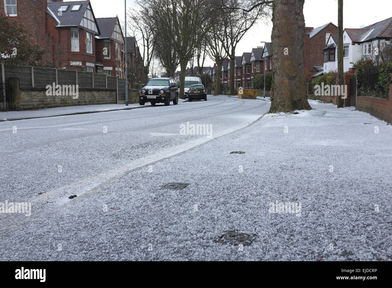 Manchester UK 24th March 2015 A fiveminute hail shower leaves Victoria Avenue in Didsbury
