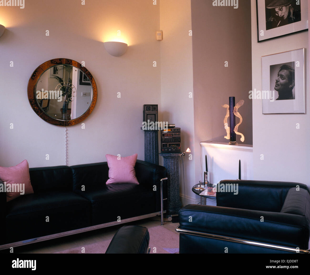 Black leather+chrome sofa and armchair in an eighties living room Stock