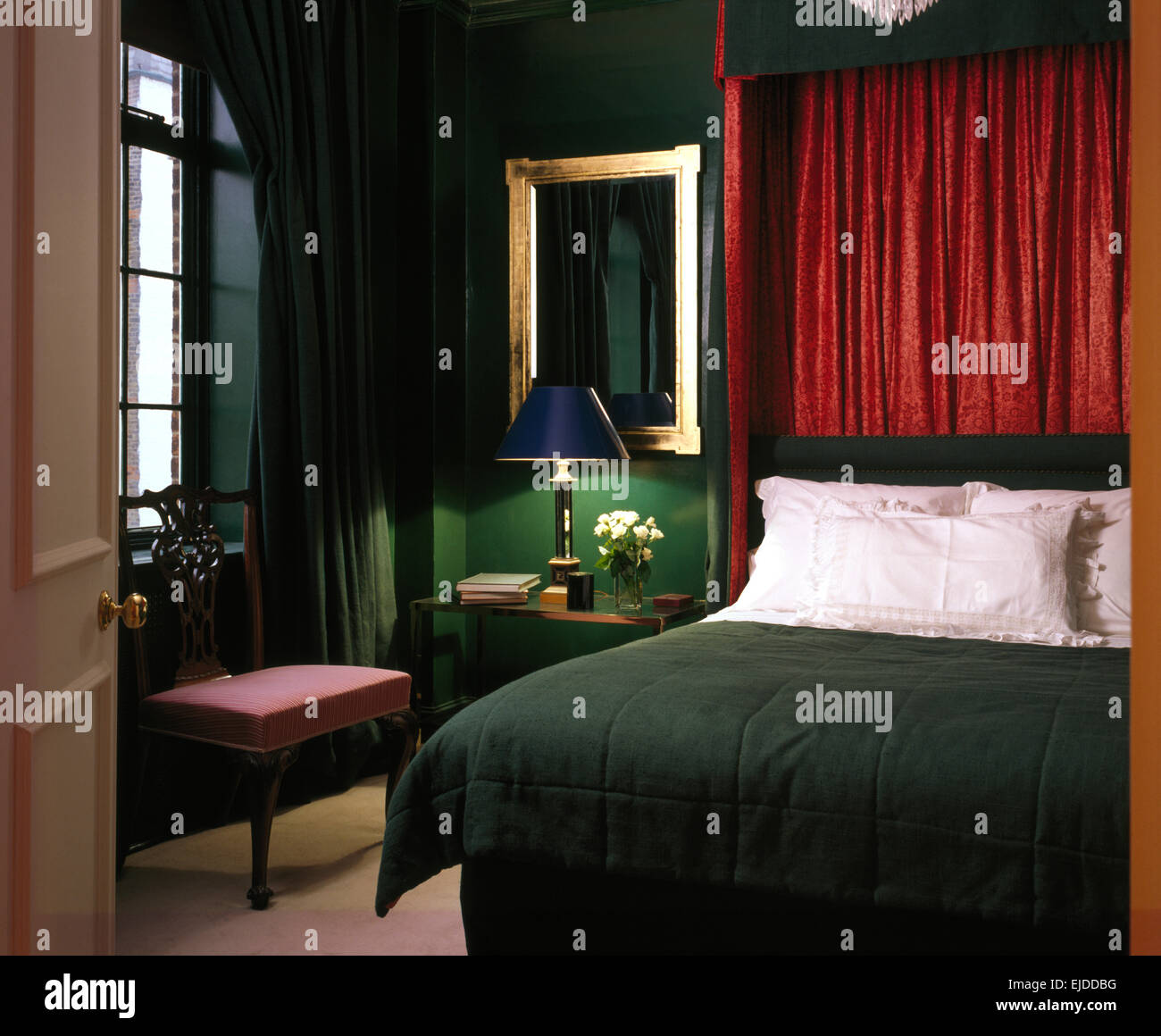 Red Drapes On Half Tester Bed With White Pillows And Dark Green