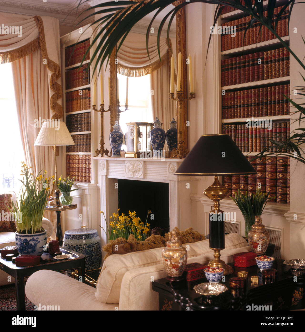 Fitted bookcases on either side of fireplace in opulent