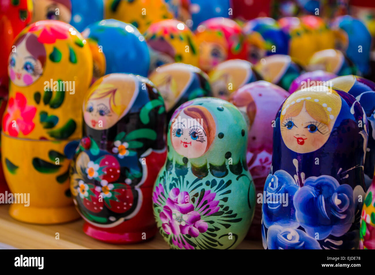 Colorful rows of russian puzzle dolls in different colors and designs