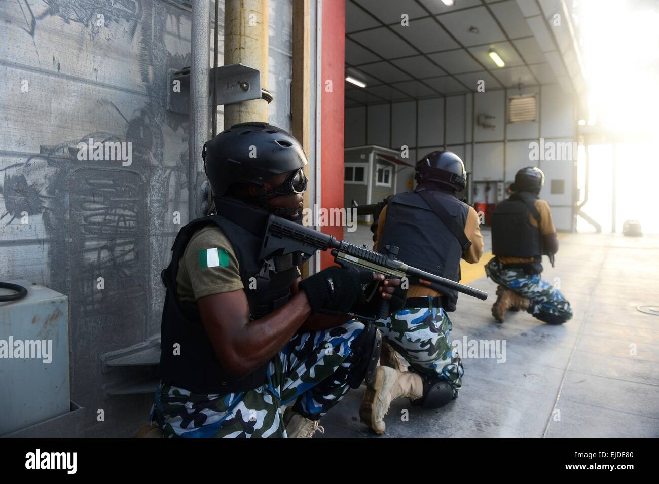 Nigerian military special operations commandos establish security during a visit, board, search and seizure drill aboard the Military Sealift Command's joint high-speed vessel USNS Spearhead as part of Obangame Express March 20, 2015 in the Gulf of Guinea. Stock Photo