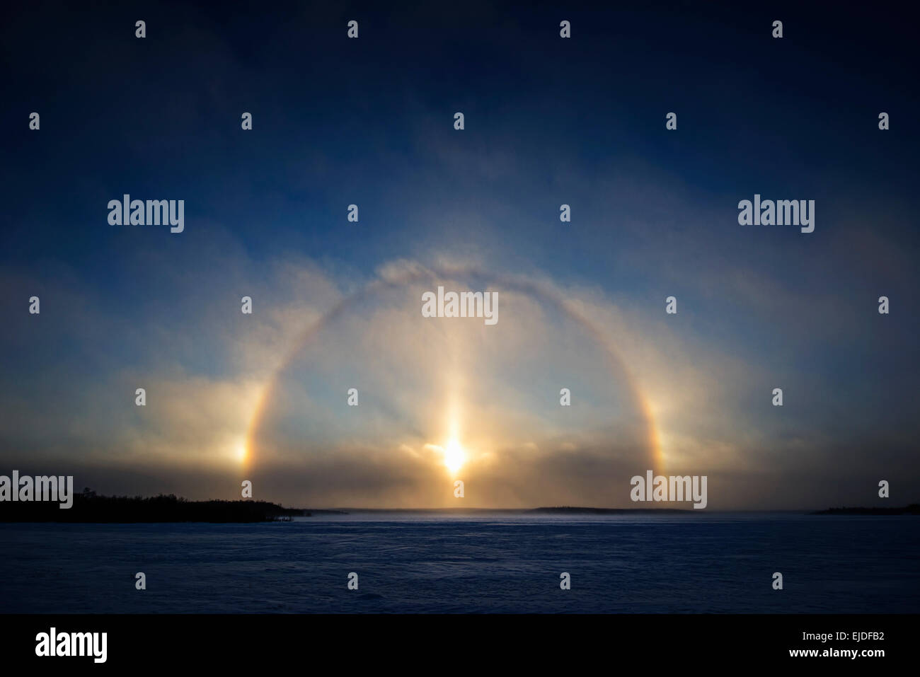 A Sundog, Parhelia or Mock Sun, is created by ice crystals in the atmosphere. Three sundogs and a halo of light. phenomenon Stock Photo