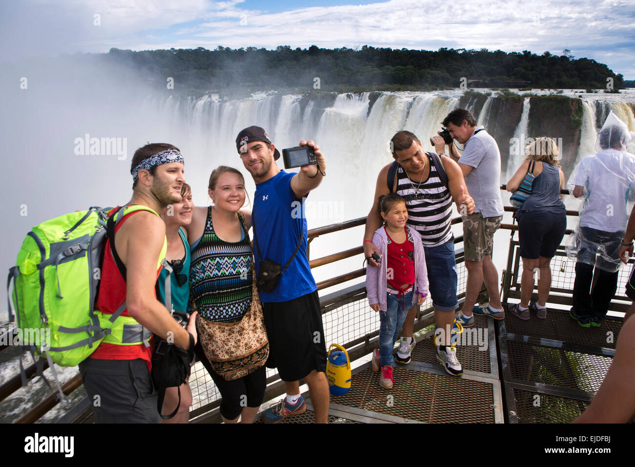 Argentina, Iguazu Falls National Park, tourists taking selfie at Garganta el Diablo waterfall viewpoint Stock Photo