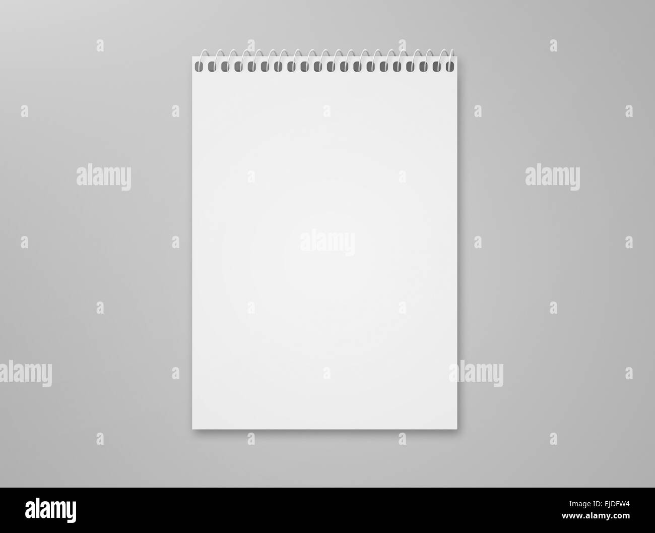 Blank notebook sketch pad with metal spiral with lots of copy space, isolated on a gray background with shadow. Stock Photo