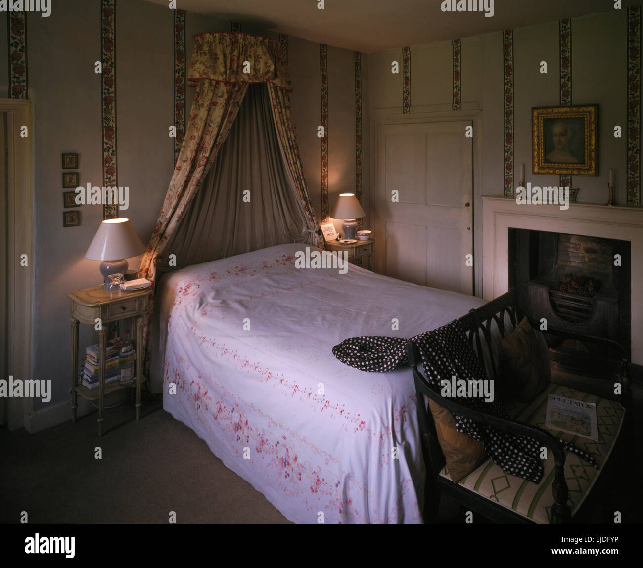 Lighted Lamps Either Side Of Bed With Coronet And Drapes And