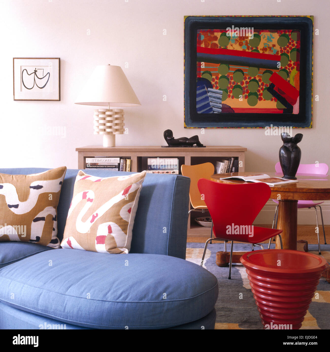 Patterned cushions on pale blue sofa in sitting room and