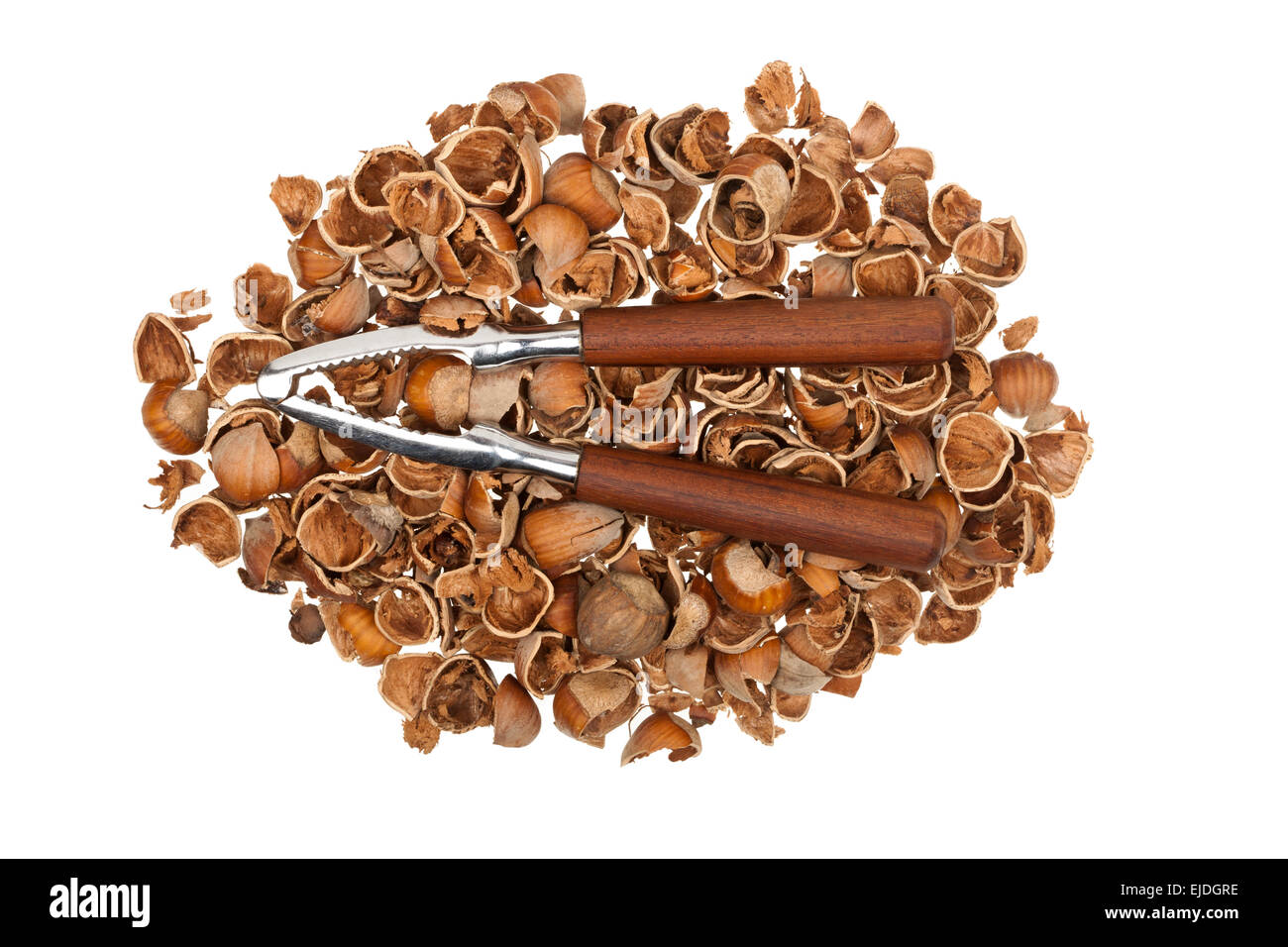 Nutcracker on a pile of empty nutshells isolated on white background ...